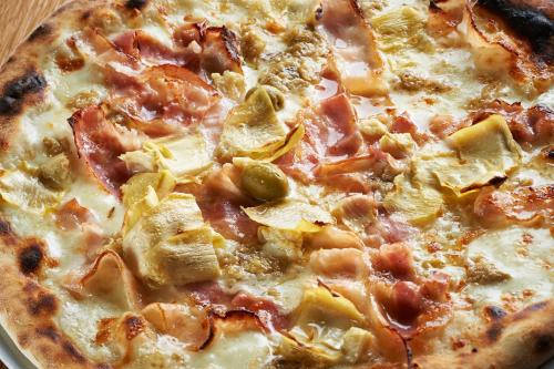 a pizza sitting on top of a table at Hotel Delfin in Izola