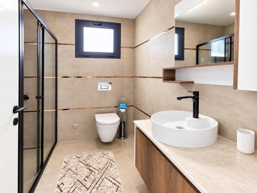 a bathroom with a sink and a toilet at Blue life Long beach in Iskele