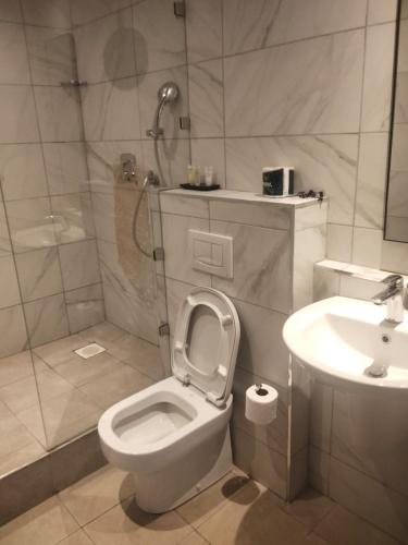 a bathroom with a toilet and a sink at Hidden Gem With Accomodation, Restaurant, Bar & Spa in Nairobi