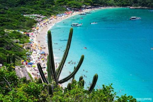 a view of a beach with people in the water at Pousada Palmares in Cabo Frio