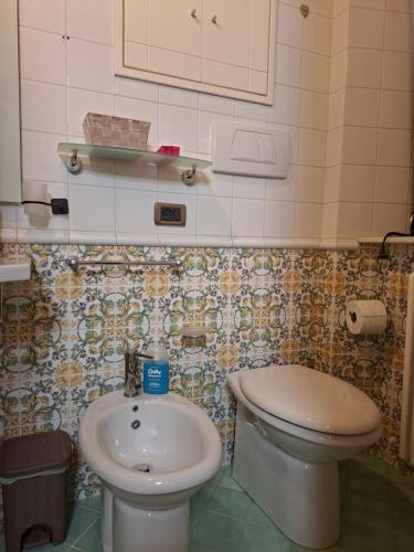 a bathroom with a toilet and a sink at B&B Dimora D'Alfano in SantʼAngelo in Pontano