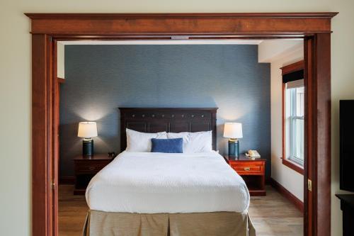 a bedroom with a large bed with blue walls at Rodd Crowbush Golf & Beach Resort in Morell