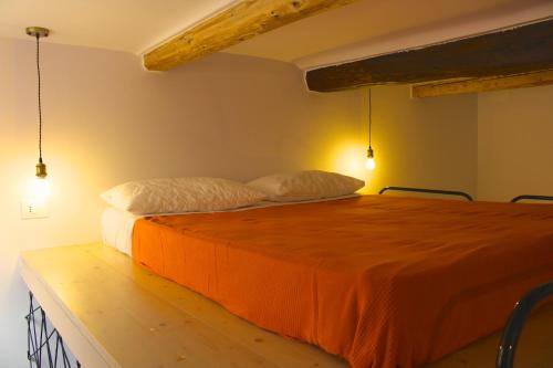 a bed in a room with two pillows on it at Appartamento della Baia in Sestri Levante