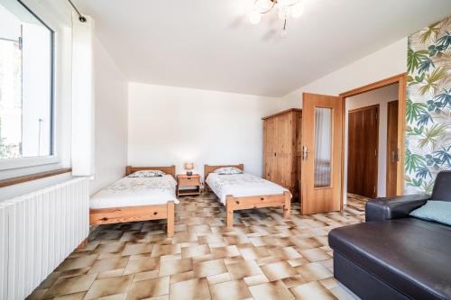 a living room with two beds and a couch at Gîte Du Noiret in Cruseilles