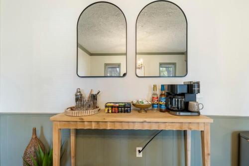 a table with a coffee maker and two mirrors at Aspen Pool House- 1 Mile From OU in Norman
