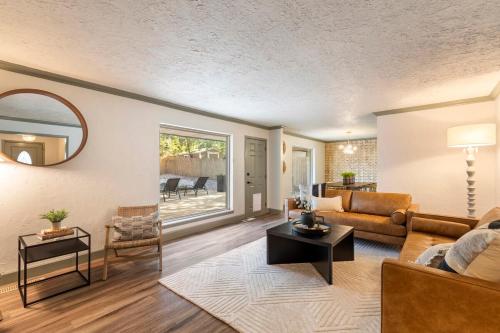 a living room with a couch and a table at Aspen Pool House- 1 Mile From OU in Norman