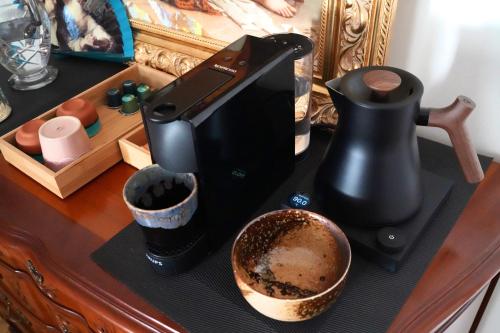 a coffee maker sitting on top of a table at Chambre confort - Le Boudoir in Hendaye