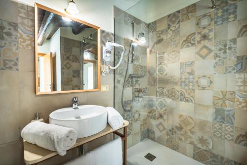 a bathroom with a sink and a shower at ChocoHouse in Ragusa