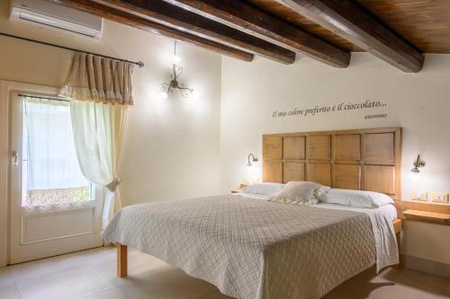 a bedroom with a bed and a window at ChocoHouse in Ragusa