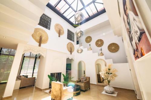 a living room with a vaulted ceiling and a skylight at Al Maaden Villa Hotel & Spa in Marrakesh