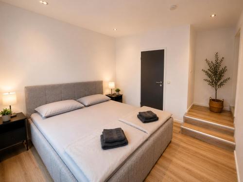 a bedroom with a large bed with two towels on it at PaderQuartier2 in Paderborn