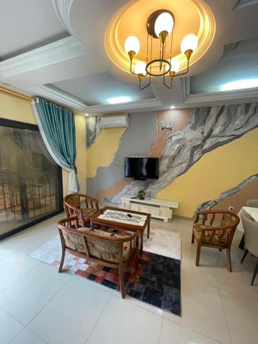 a living room with a painting on the wall at Résidences Quezia in Libreville