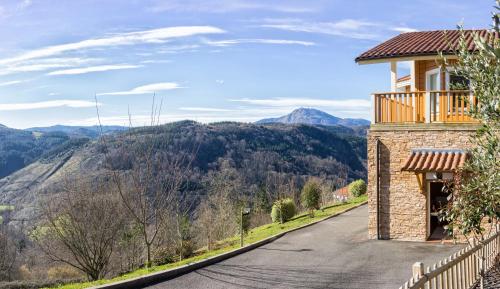 a road leading to a house with a balcony at Arbegain Etxea in Aizarna