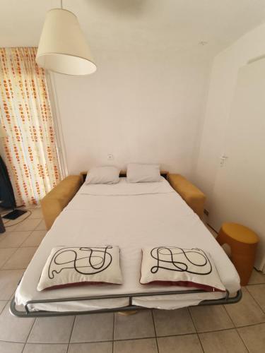a bed with two pillows on it in a room at Studio Prayssac in Prayssac