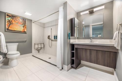 a bathroom with a sink and a toilet and a shower at Hilton Vacation Club Palm Canyon Palm Springs in Palm Springs