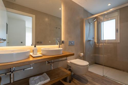 a bathroom with a sink and a toilet and a shower at Modern Villa Olivera with Private Pool in Calella de Palafrugell