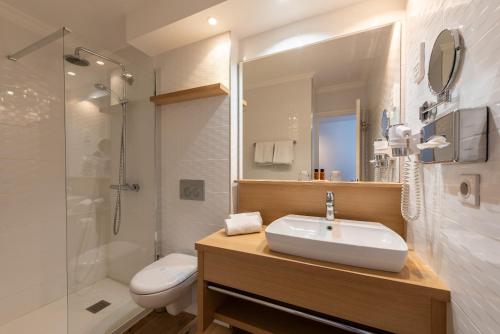a bathroom with a sink and a toilet and a shower at Le Petit Prince in Sainte-Maxime