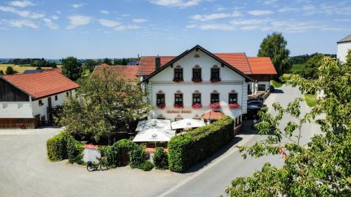 an aerial view of a large white house at Gasthaus Stoiber in Buchbach
