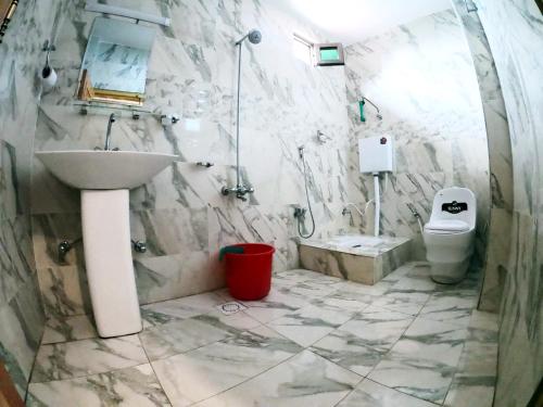 a bathroom with a sink and a toilet at Snow Land Hotel and Restaurant in Malam Jabba