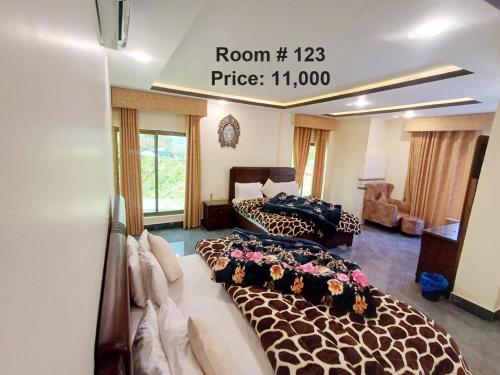 a room with two beds and a sign that reads room price at Snow Land Hotel and Restaurant in Malam Jabba