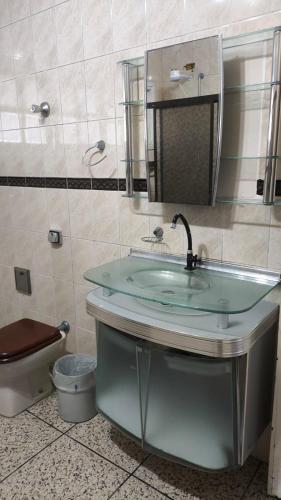 a bathroom with a sink and a toilet at Pousada Pontal de Santa Marina - Caraguatatuba in Caraguatatuba