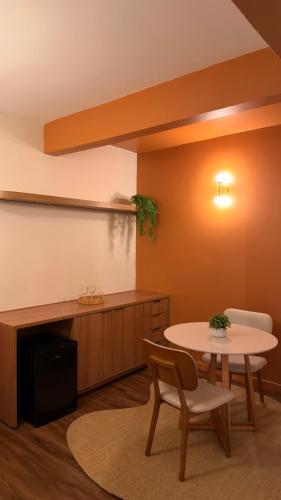 a room with a table and a table and chairs at Palace Hotel Três Poderes in Frutal