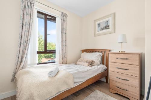 a bedroom with a bed and a window at The Nest in Belfast