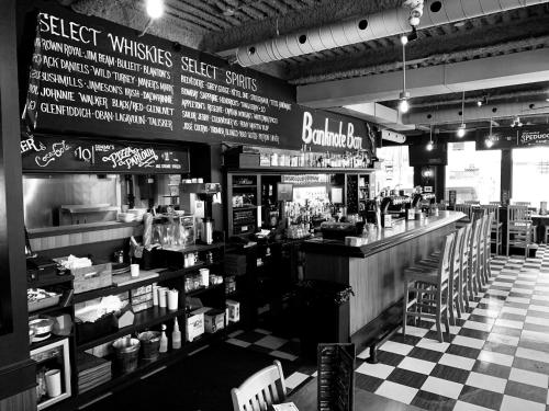 a black and white photo of a bar in a restaurant at Holiday Inn Express Toronto Downtown by IHG in Toronto