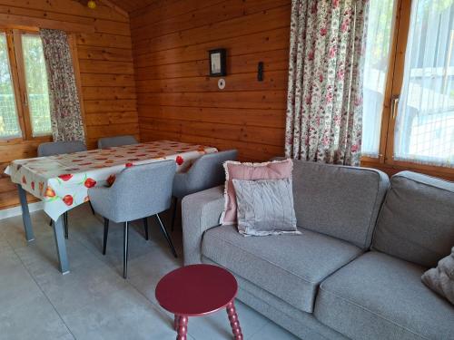 a living room with a couch and a table at Oase van rust in Poortvliet