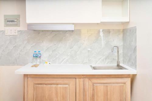 a kitchen with a sink and a counter top at ROSE Appartment in Ho Chi Minh City