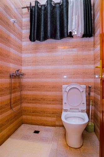 a bathroom with a toilet and a shower at Martin Aviator Apartment in Kigali