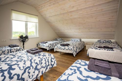 a room with four beds and a window at Sepa puhkemaja in Pärnu