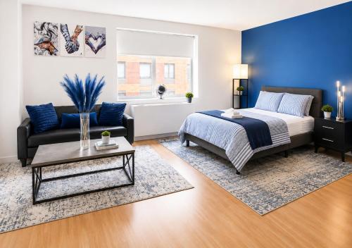 a bedroom with a bed and a couch at Studio apart Time Square in New York