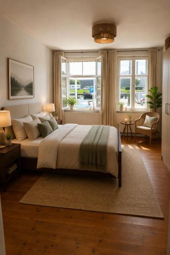 a bedroom with a large bed and a large window at Gästehaus Am Hafen 7 Glückstadt in Glückstadt