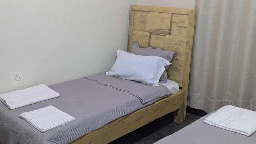 a bed with two pillows on it in a room at CJ Apartments in Kapchorwa
