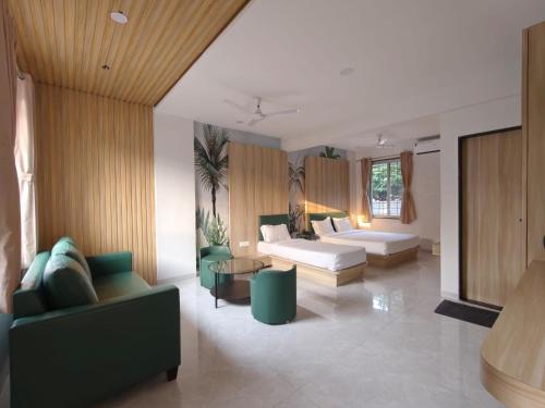 a living room with two couches and a couch at Sukhawan Hotel in Kalamb