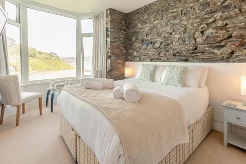 a bedroom with a large bed with towels on it at 4 Bed in Looe oc-l30051 in Looe