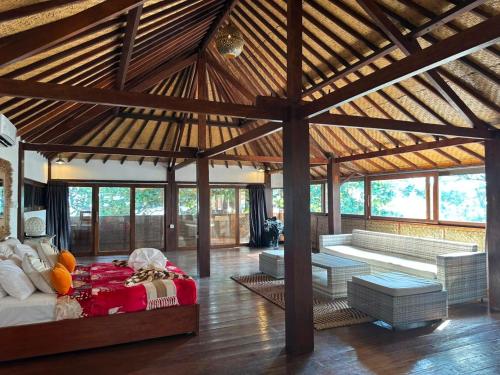 a pavilion with a bed and a couch in a room at My happy place loft gili air in Gili Islands