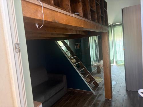 a loft bed in a room with a staircase at Evasion Suite parentale in La Couronne