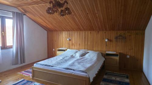 a bedroom with a bed with a wooden ceiling at Holiday Home Nana in Bugojno