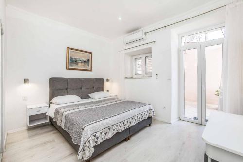 a bedroom with a bed and a large window at Villa Adriatic Pearl in Dubrovnik