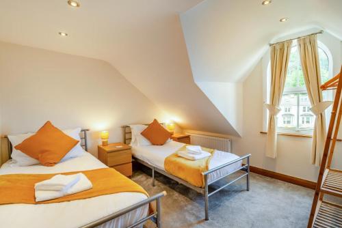 two beds in a room with a window at 3 Bed in Sandsend oc-wa081 in Sandsend