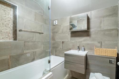 a bathroom with a tub and a sink and a shower at 3 Bed in Sandsend oc-wa081 in Sandsend