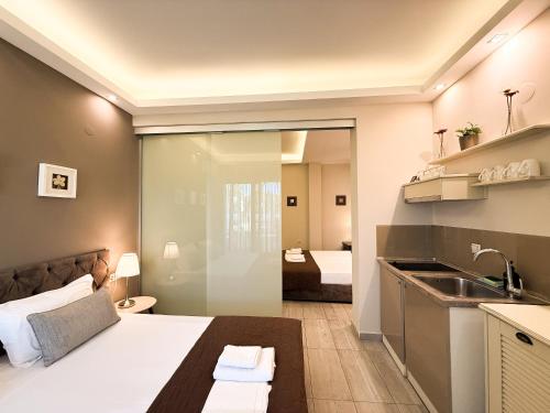 a bedroom with a bed and a sink in a room at Aroma Villa & Studios in Limenas