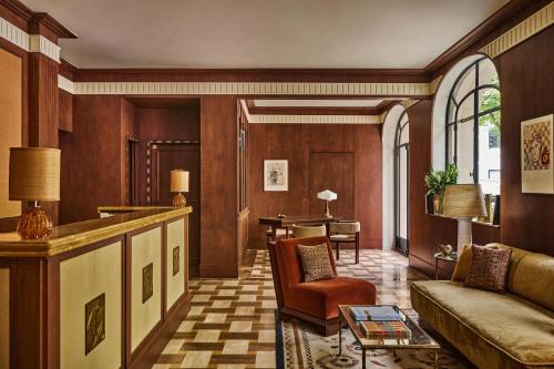 a living room with a couch and a table at Hôtel Madison in Paris