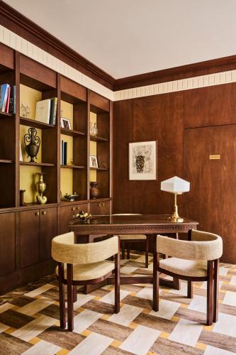 a living room with a table and two chairs at Hôtel Madison in Paris