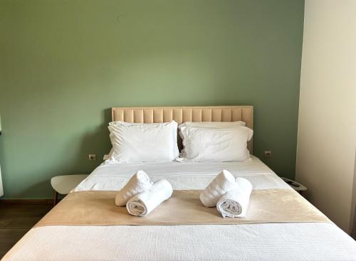 a bed with two rolled towels on top of it at Boho House Florina in Florina