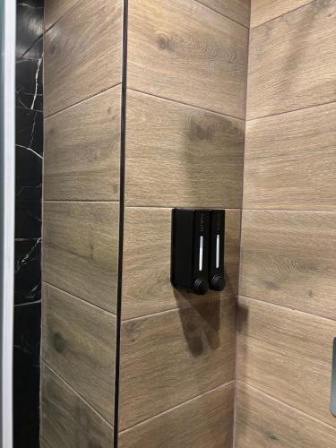 a wooden cabinet with three knives in a bathroom at Boho House Florina in Florina