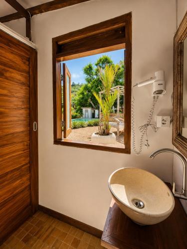 a bathroom with a sink and a window at 5BR, Ocean View, Private Pool, Villas Roc-Azur in Sampalan