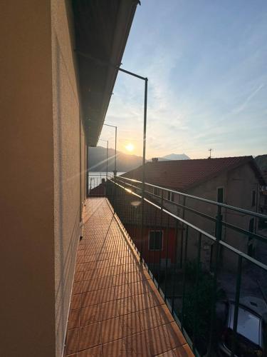 a balcony of a building with the sunset in the background at Olcium Holiday Rooms in Mandello del Lario